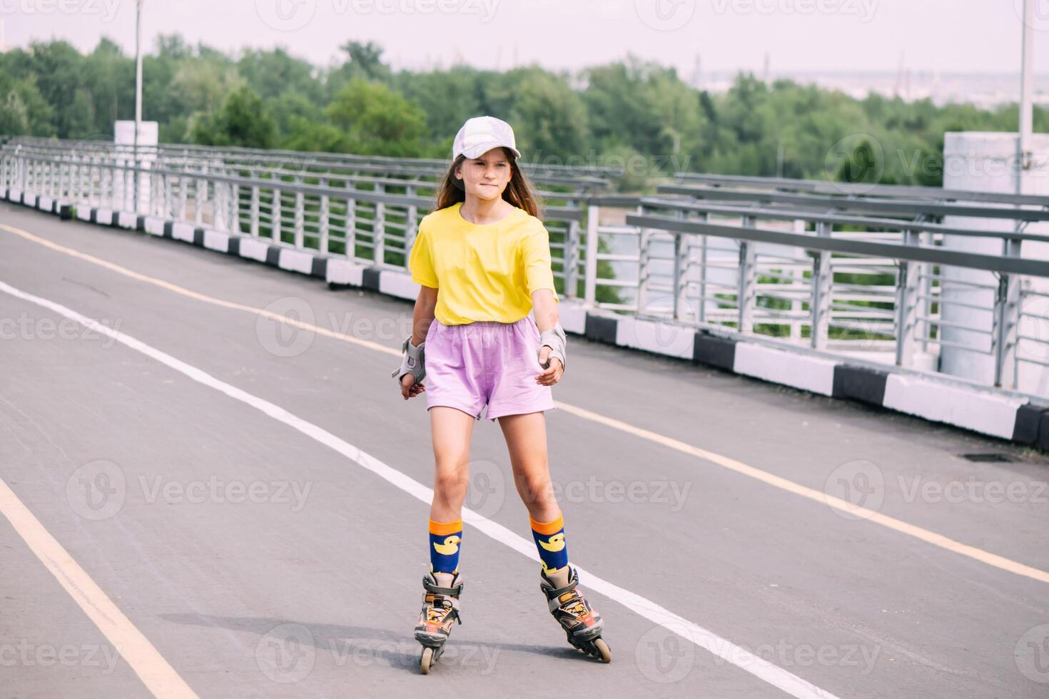 Preteen girl roller skating in the park, doing outdoor activities. Horizontal frame photo