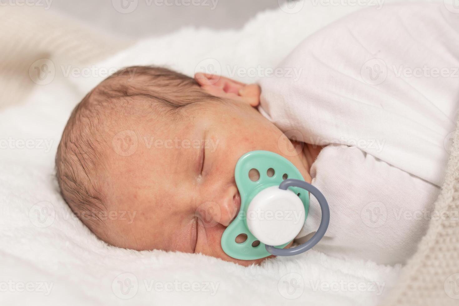 Sleeping newborn baby with pacifier white blanket, an emotional portrait of 7 days old baby photo