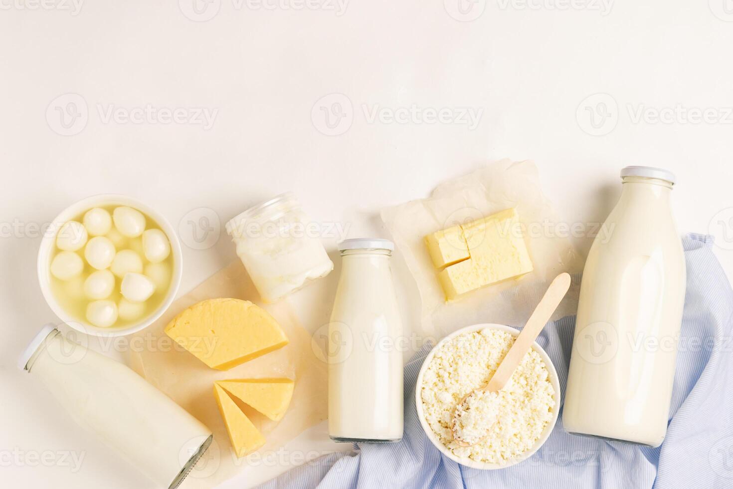 Dairy and dairy products on a white background. Milk, kefir, yogurt, butter, cheese assortment. Flat layout top view. photo
