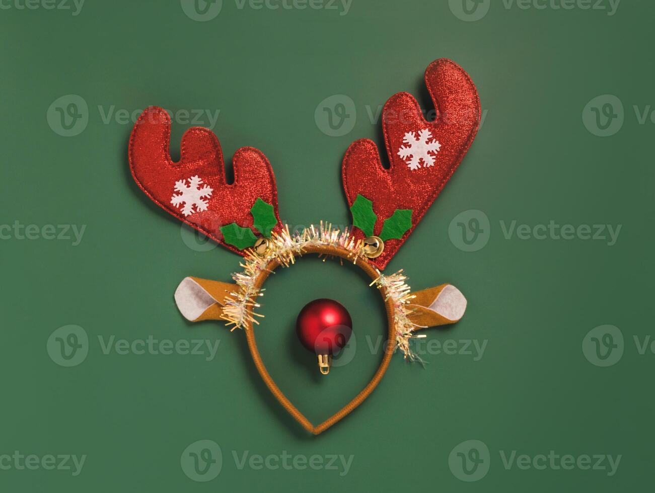 Festive layout accessories for Christmas New Year, shiny wreath of horns, toys green background photo