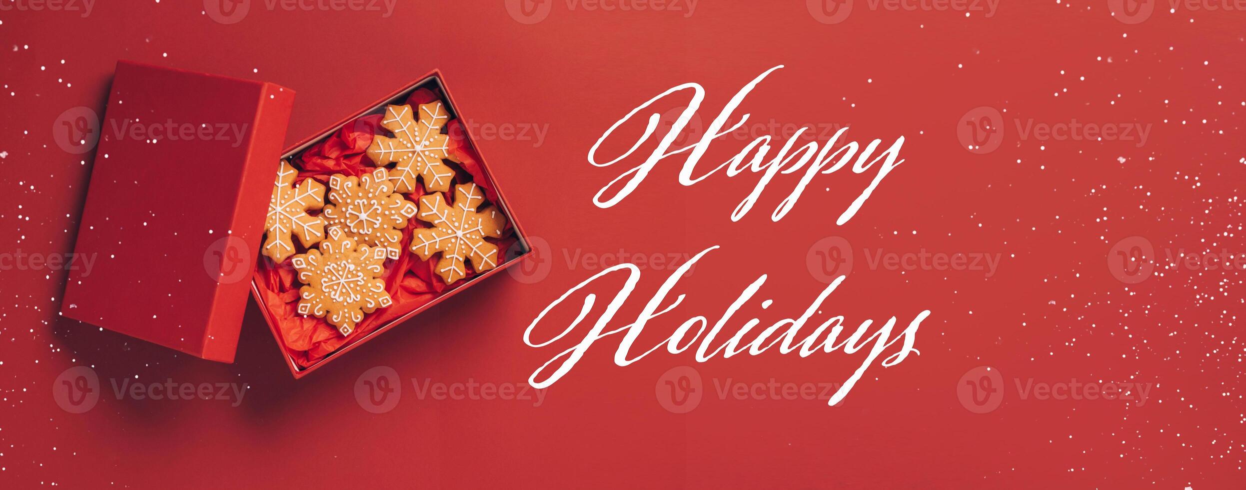 Christmas gingerbread cookies red box red festive background. Festive banner phrase Happy Holidays photo