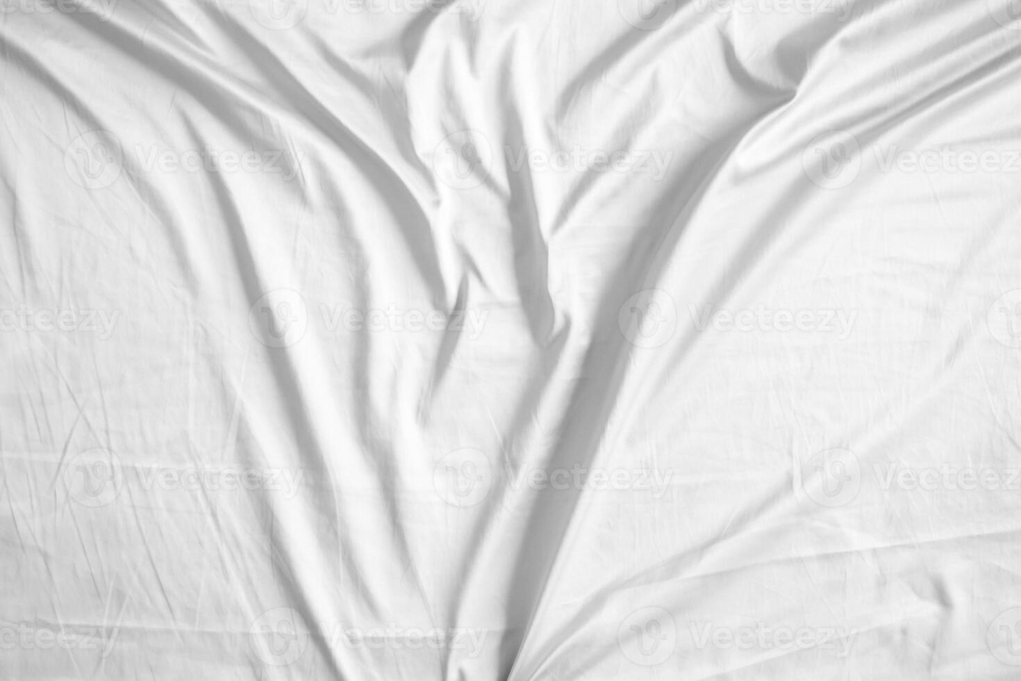 Abstract white wrinkled bedding sheet fabric texture background photo