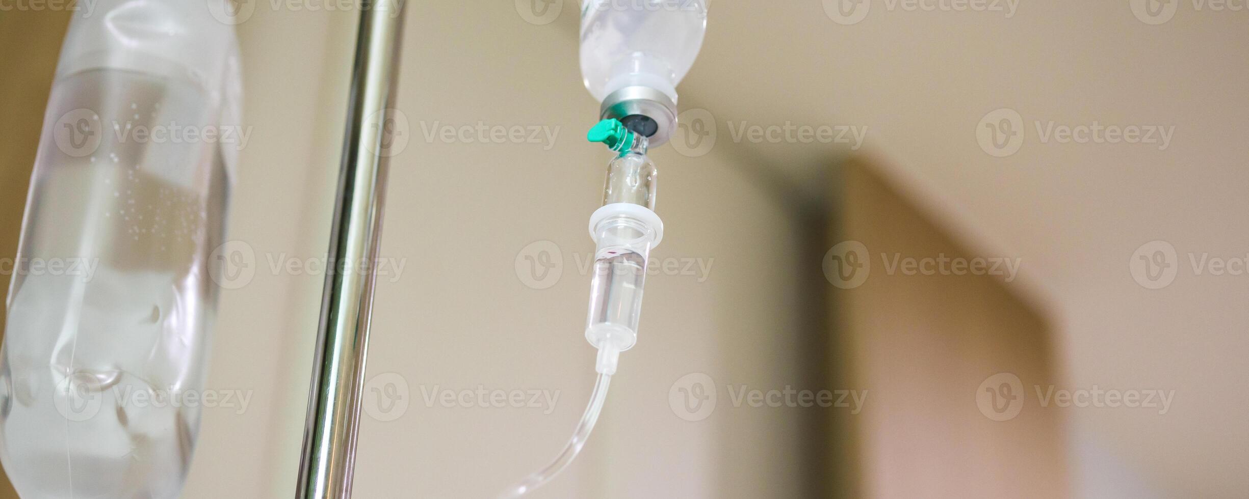 Close up medical intravenous IV drip in hospital background photo