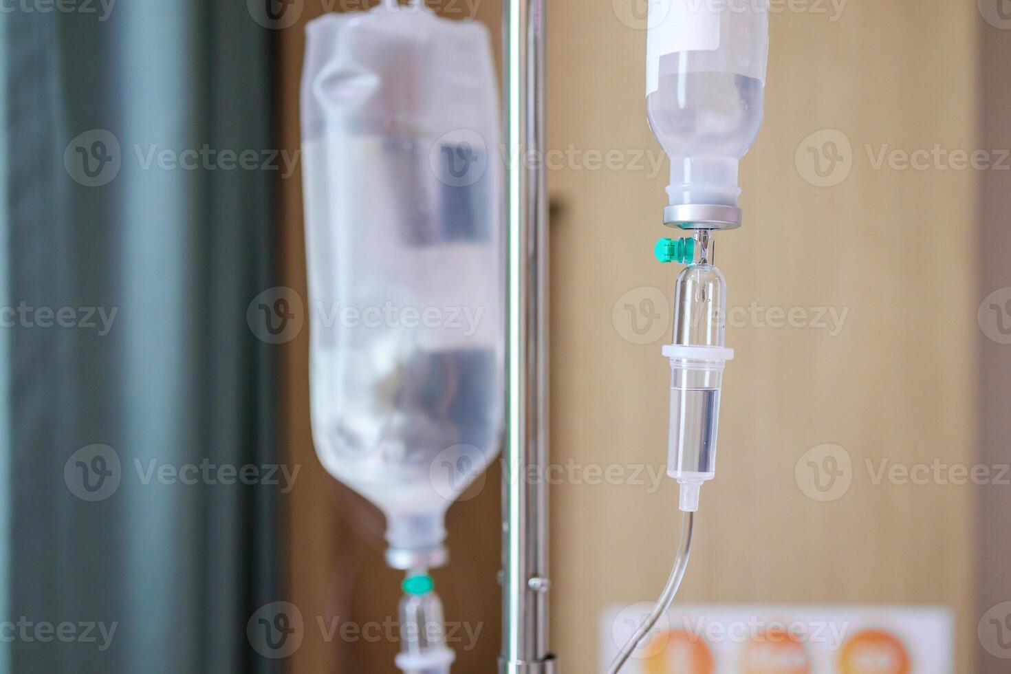 Close up medical intravenous IV drip in hospital background photo