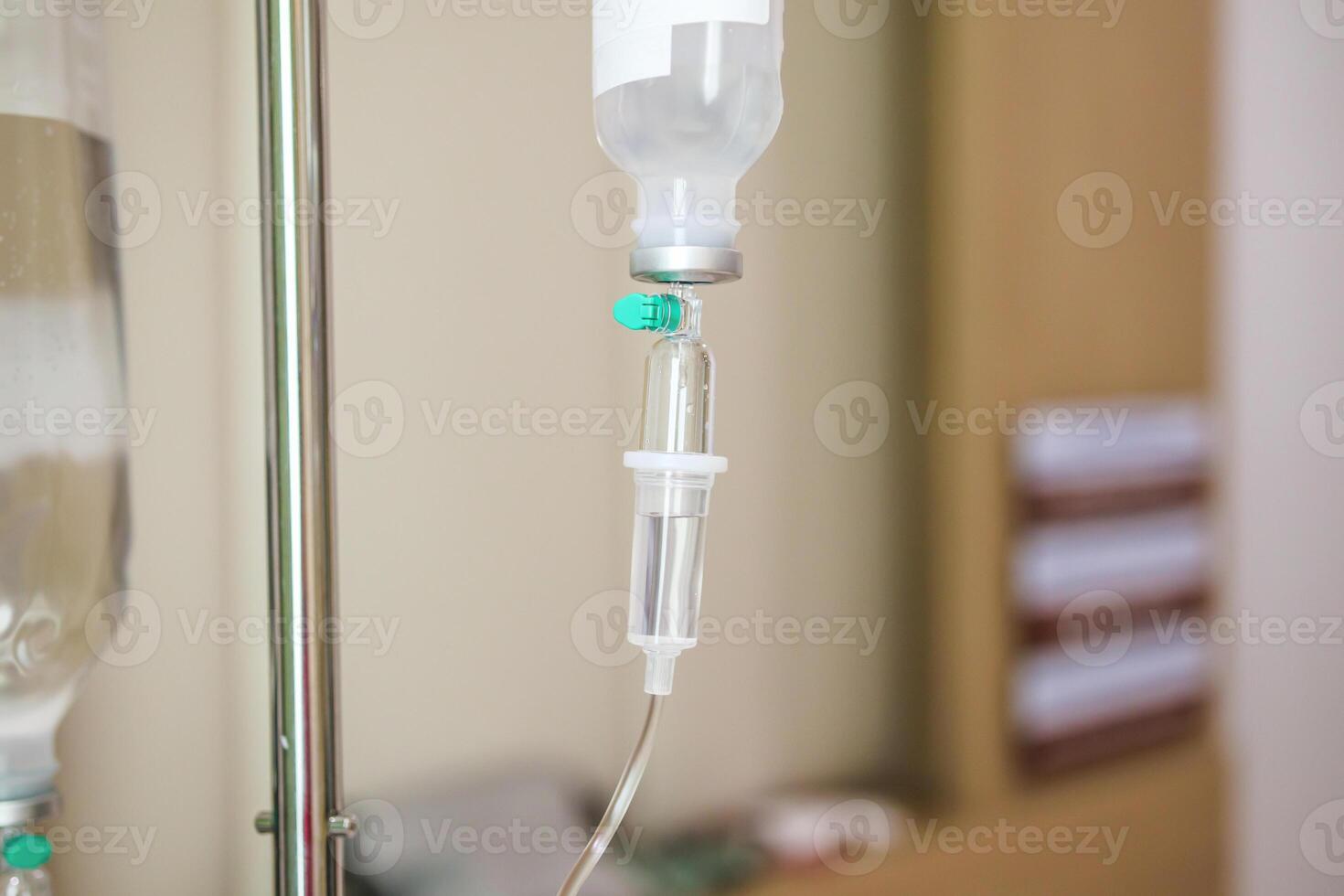 Close up medical intravenous IV drip in hospital background photo