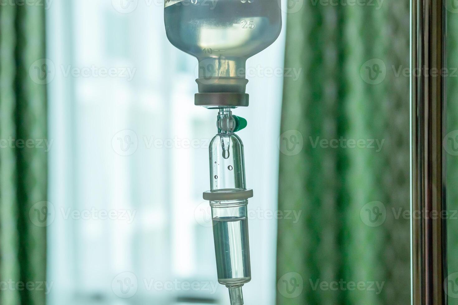 Close up medical intravenous IV drip in hospital background photo