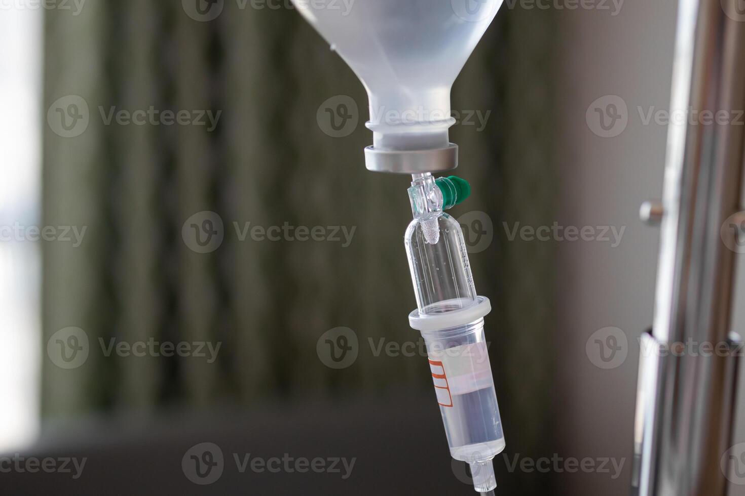 Close up medical intravenous IV drip in hospital background photo