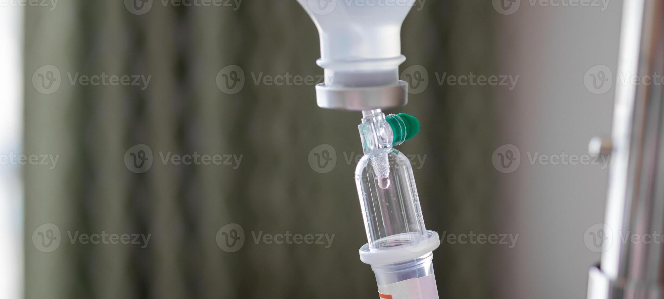 Close up medical intravenous IV drip in hospital background photo