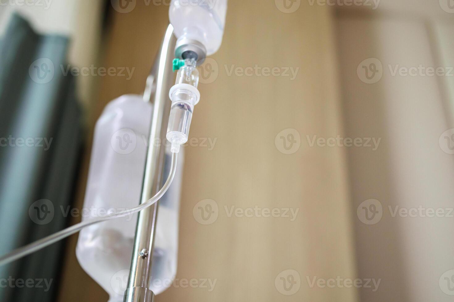 Close up medical intravenous IV drip in hospital background photo