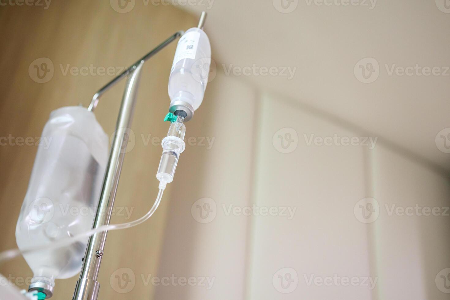 Close up medical intravenous IV drip in hospital background photo