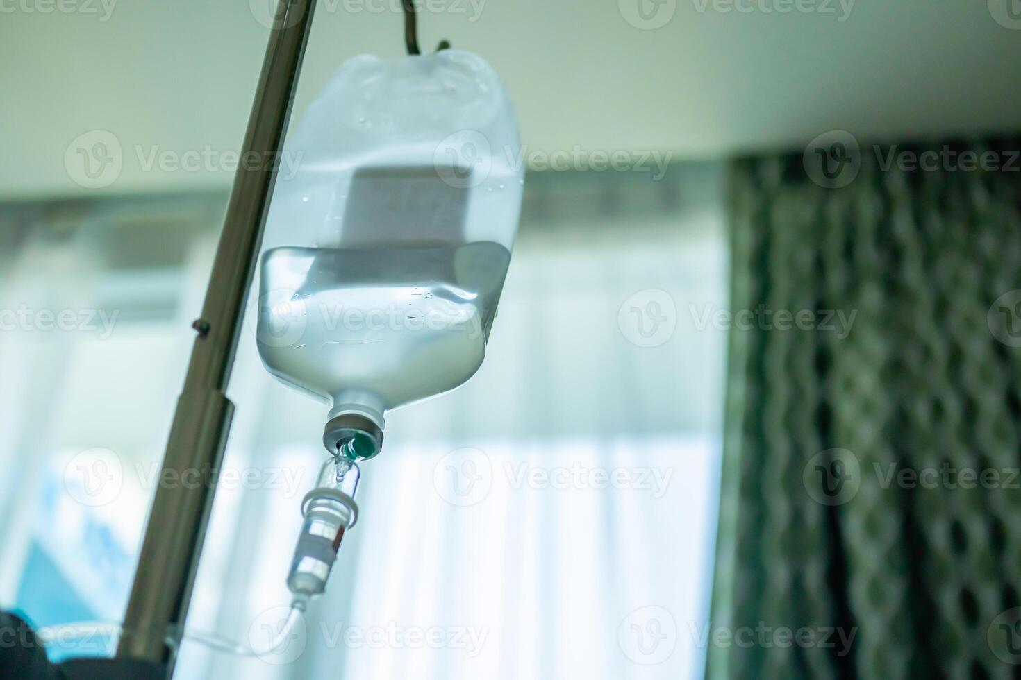 Close up medical intravenous IV drip in hospital background photo