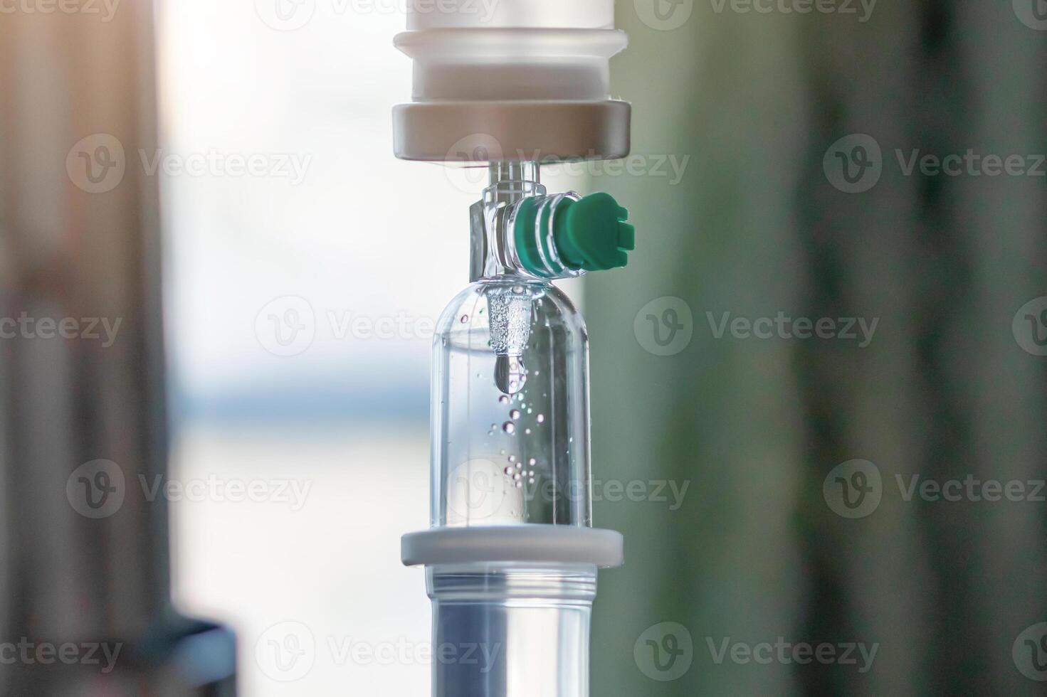 Close up medical intravenous IV drip in hospital background photo