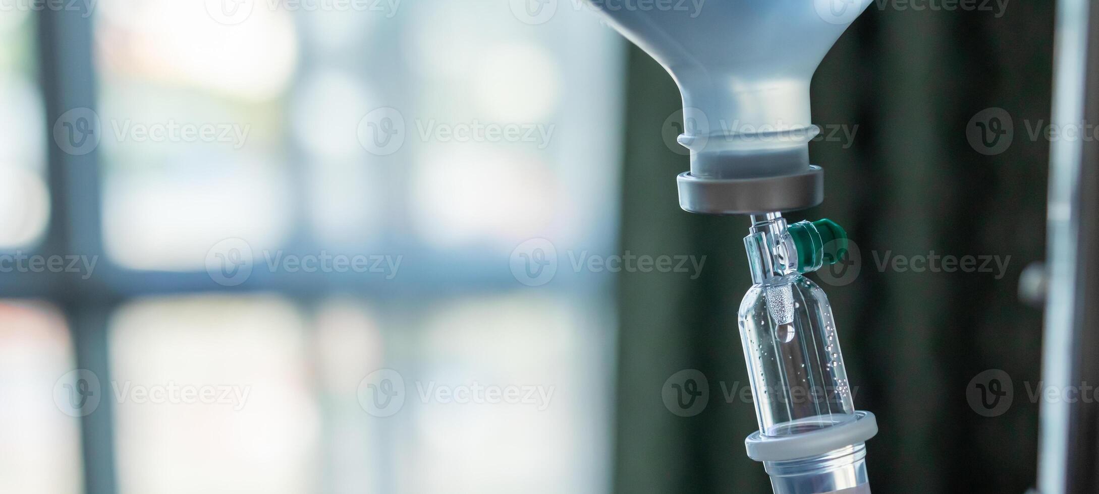 Close up medical intravenous IV drip in hospital background photo