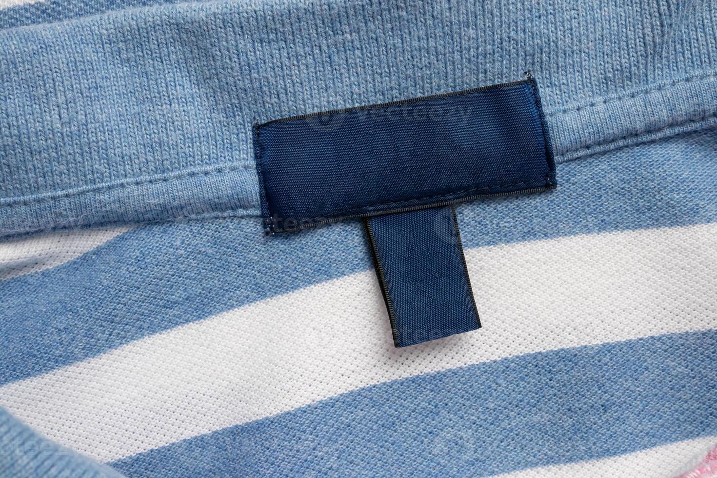Blank blue laundry care clothes label on shirt fabric texture background photo