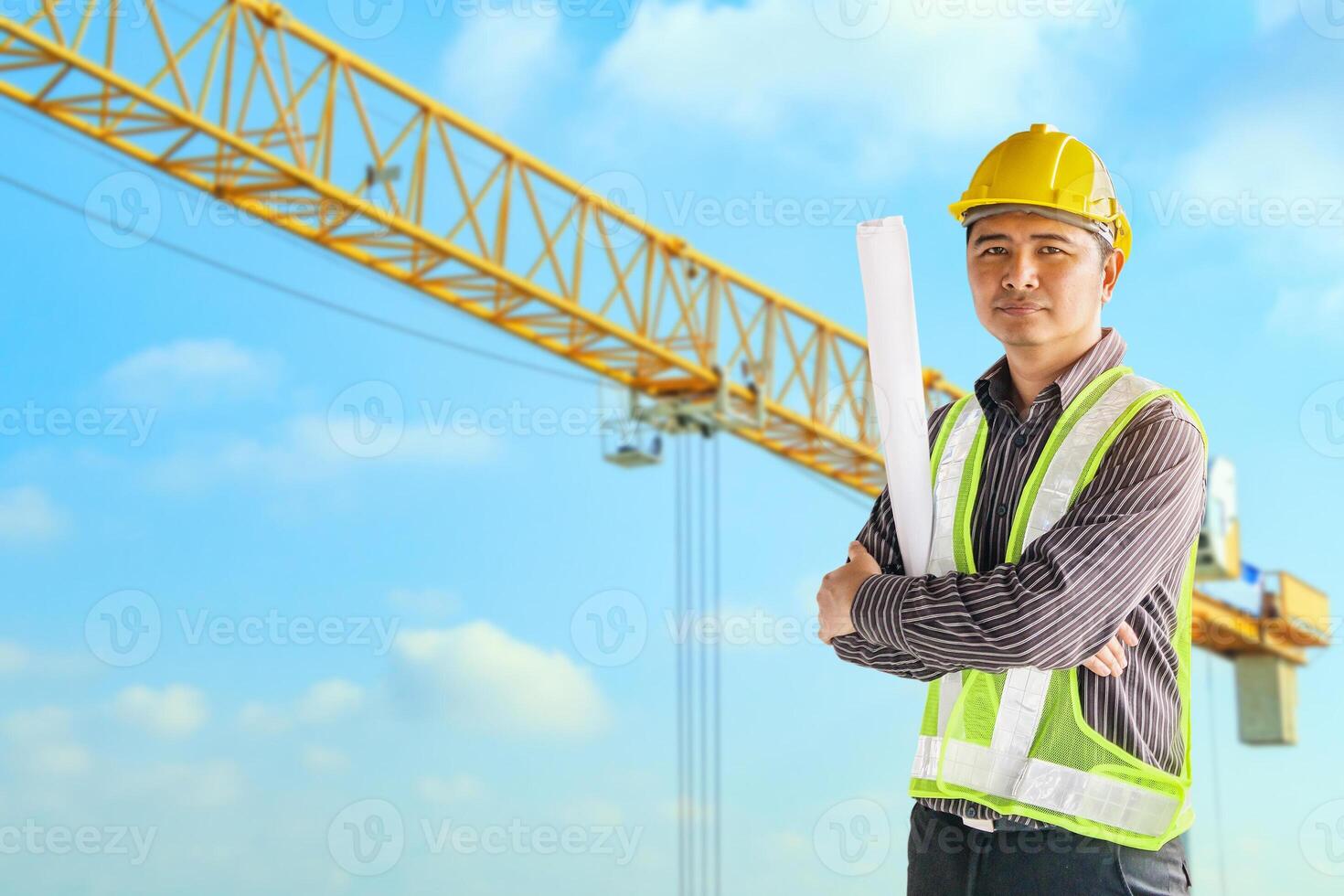 construction engineer worker in protective helmet and blueprints paper on hand at building site background photo