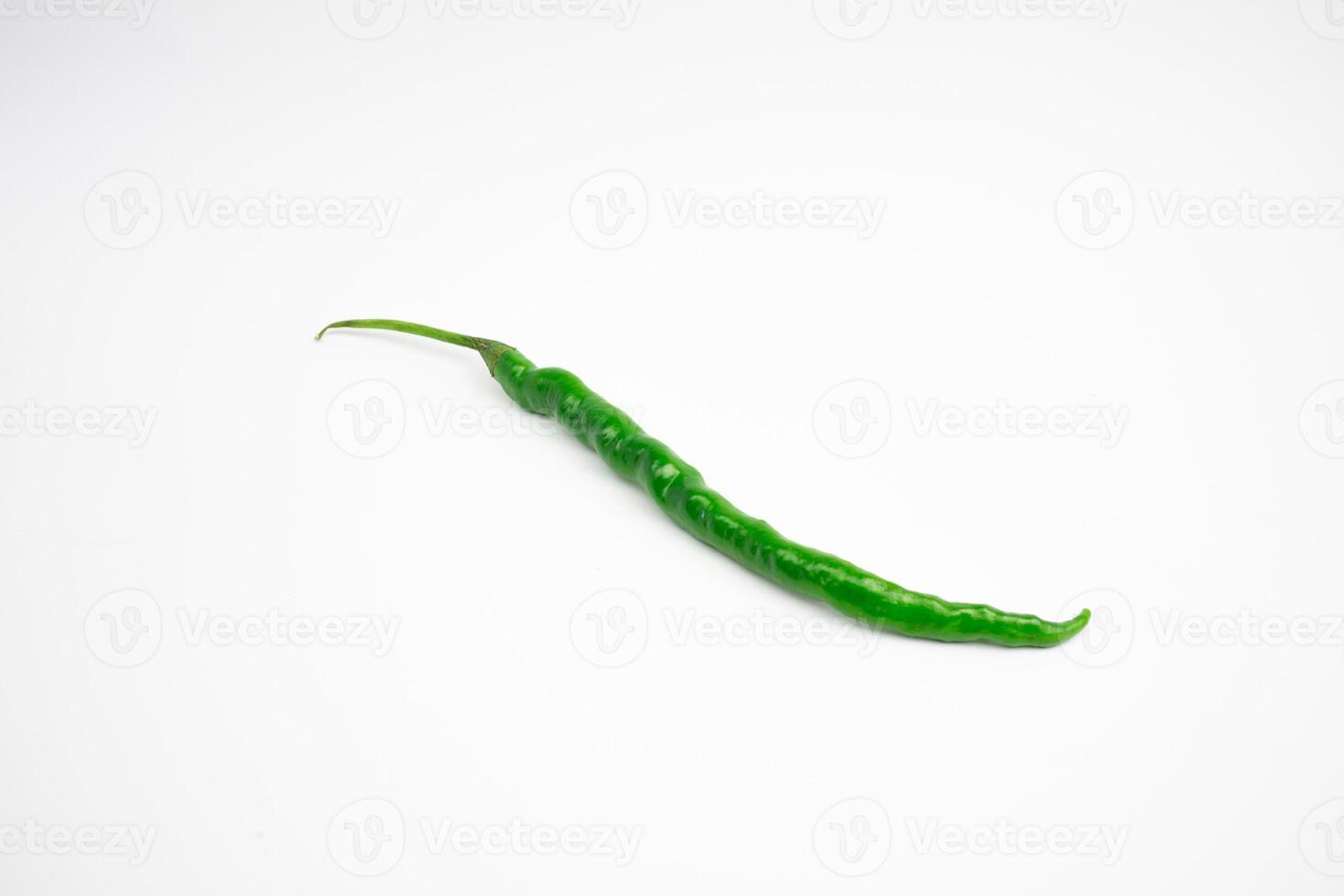 Single curly green chili. typical Indonesian, isolated on a white background. photo