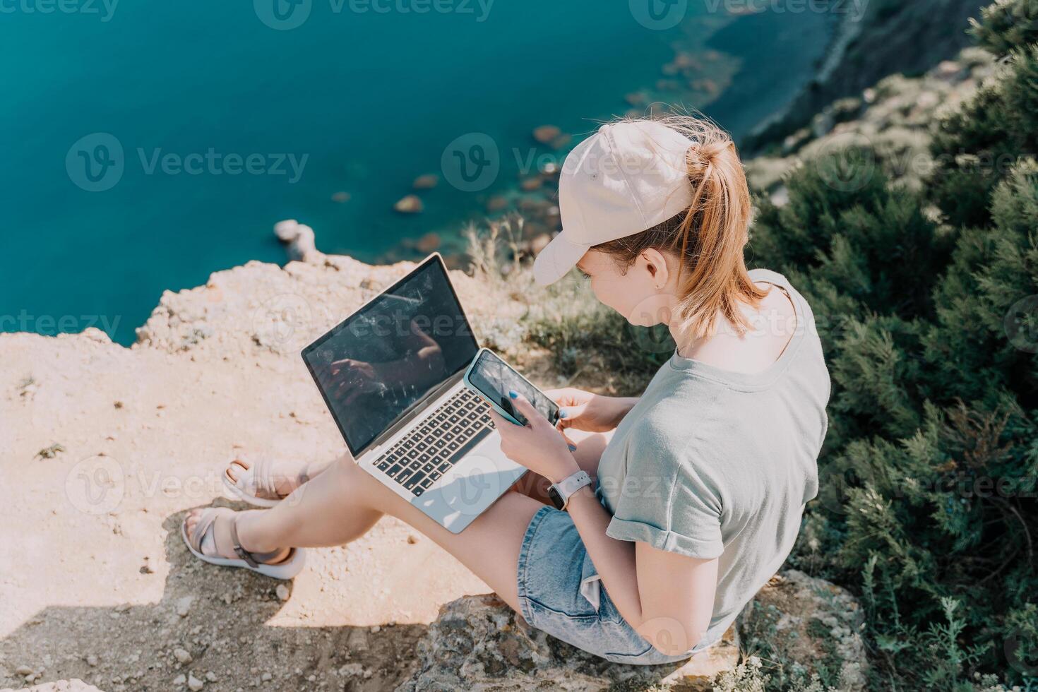 Woman sea laptop. Business woman, freelancer with laptop working over blue sea beach. Happy smiling girl relieves stress from work. Freelance, remote work on vacation, digital nomad, travel concept photo