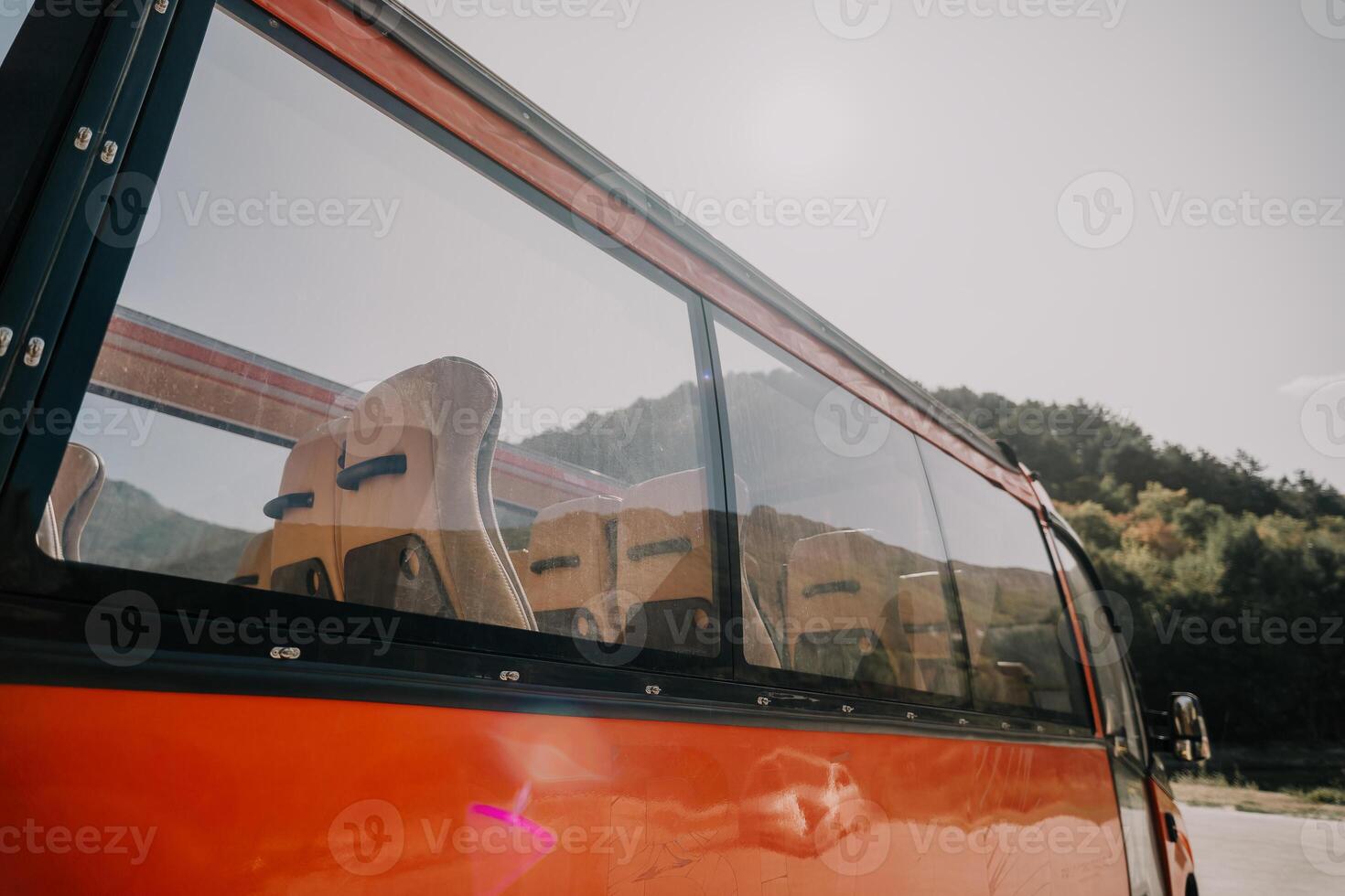 Red Bus Window with Empty Seats photo