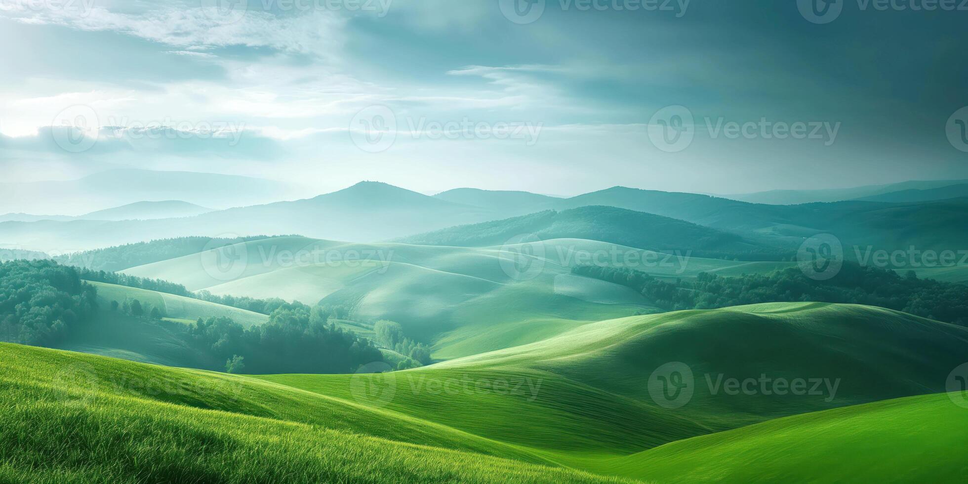 Scenic view of rolling green hills under cloudy sky, serene landscape with misty mountains in background, tranquil nature concept photo