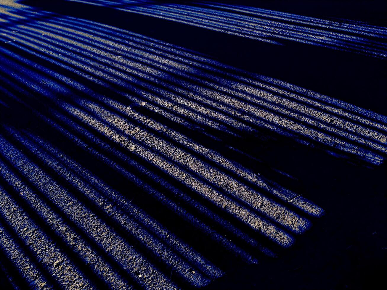 Abstract geometric from a shadow pattern on the asphalt street, long lines in monochrome tones. Copy space for text photo