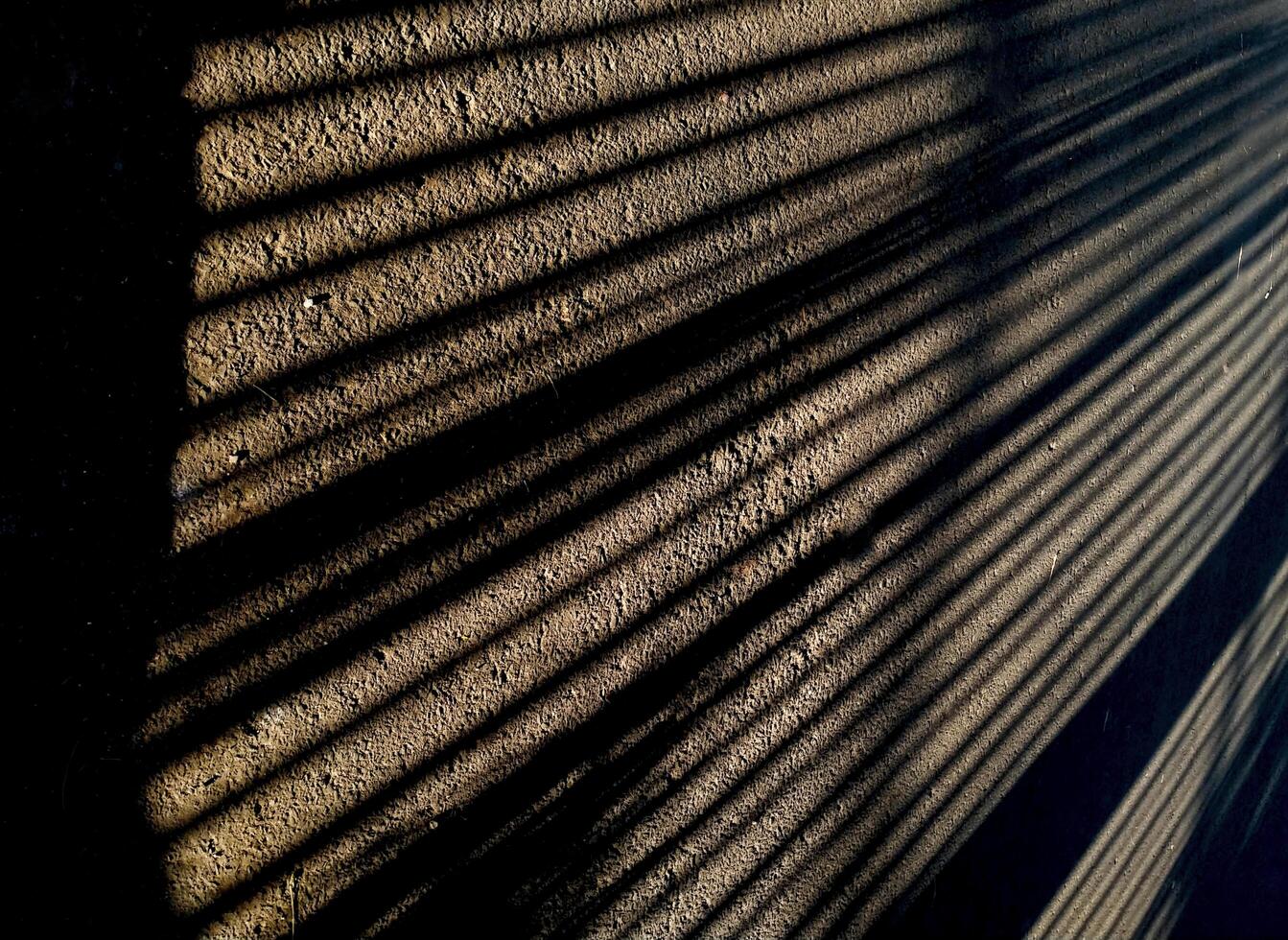 Abstract geometric from a shadow pattern on the asphalt street, long lines in monochrome tones. Copy space for text photo