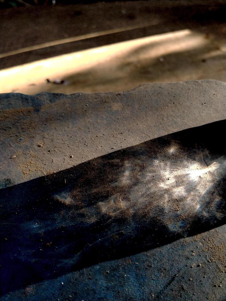 Abstract background of long shadows and sunlight on the ground. The sunlight is still yellowish in the morning and the shadows of objects can be seen faintly forming a unique texture photo