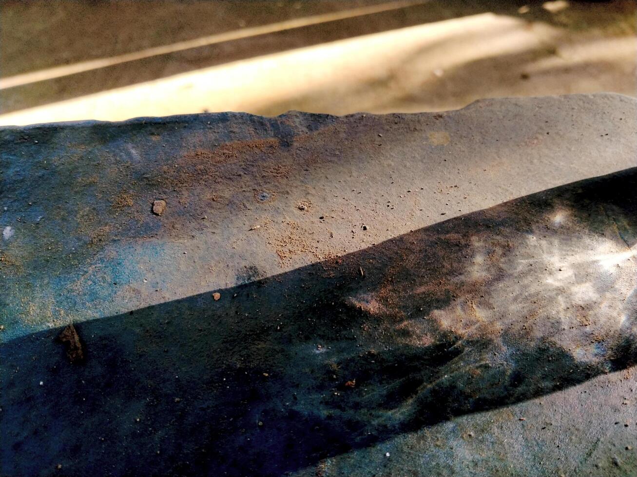 Abstract background of long shadows and sunlight on the ground. The sunlight is still yellowish in the morning and the shadows of objects can be seen faintly forming a unique texture photo