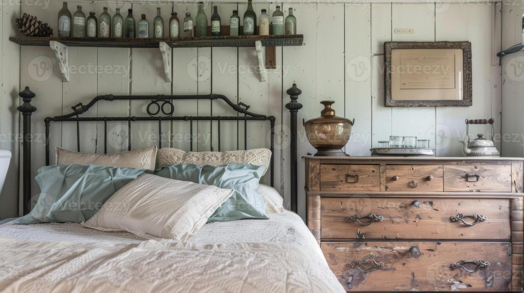 A charming farmhouse bedroom with a wrought iron bed frame a distressed wooden dresser and a collection of vintage milk bottles displayed on a shelf above the bed photo