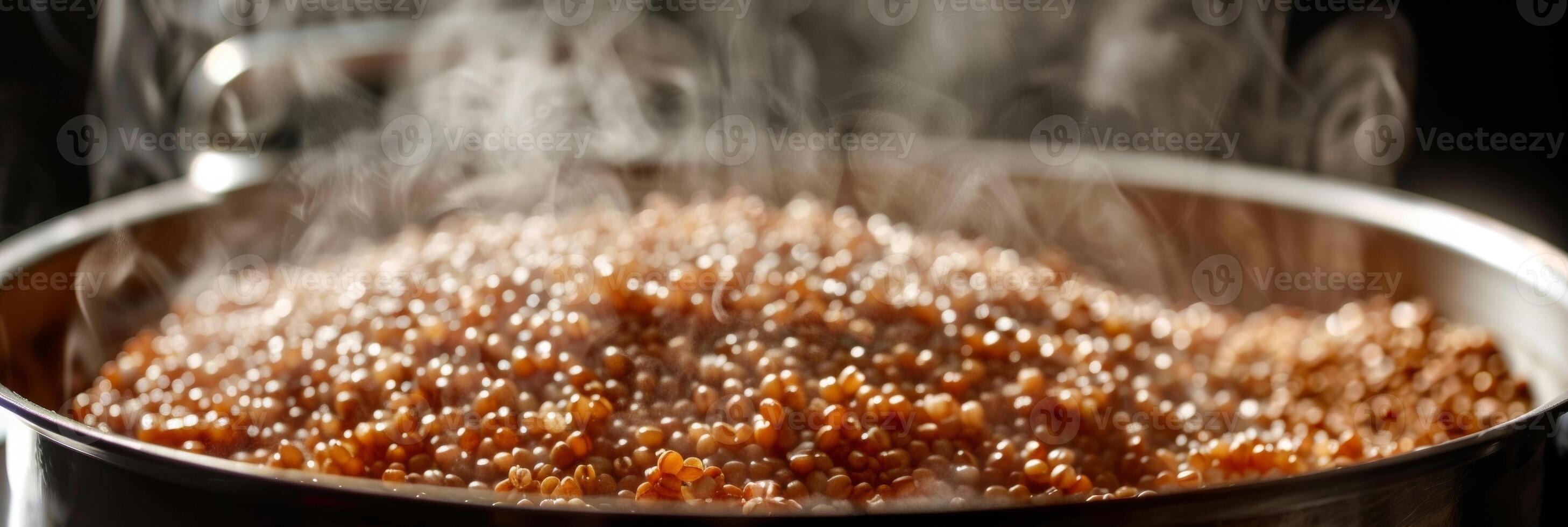 A closeup of a pot of bubbling buckwheat groats steam rising from the surface photo