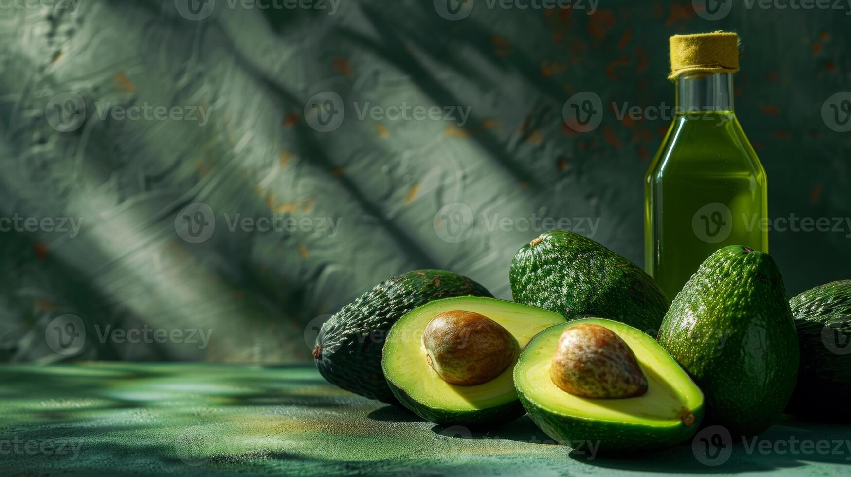 A group of avocados with one sliced open revealing the creamy texture and rich color of the fruit while a bottle of avocado oil stands next to it emphasizing its origin and benefits photo
