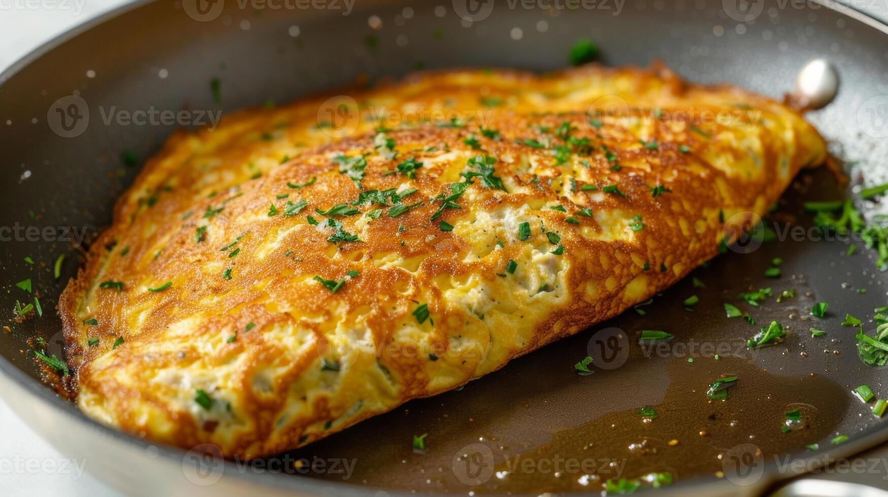 A fluffy omelette cooked in a skillet greased with avocado oil photo