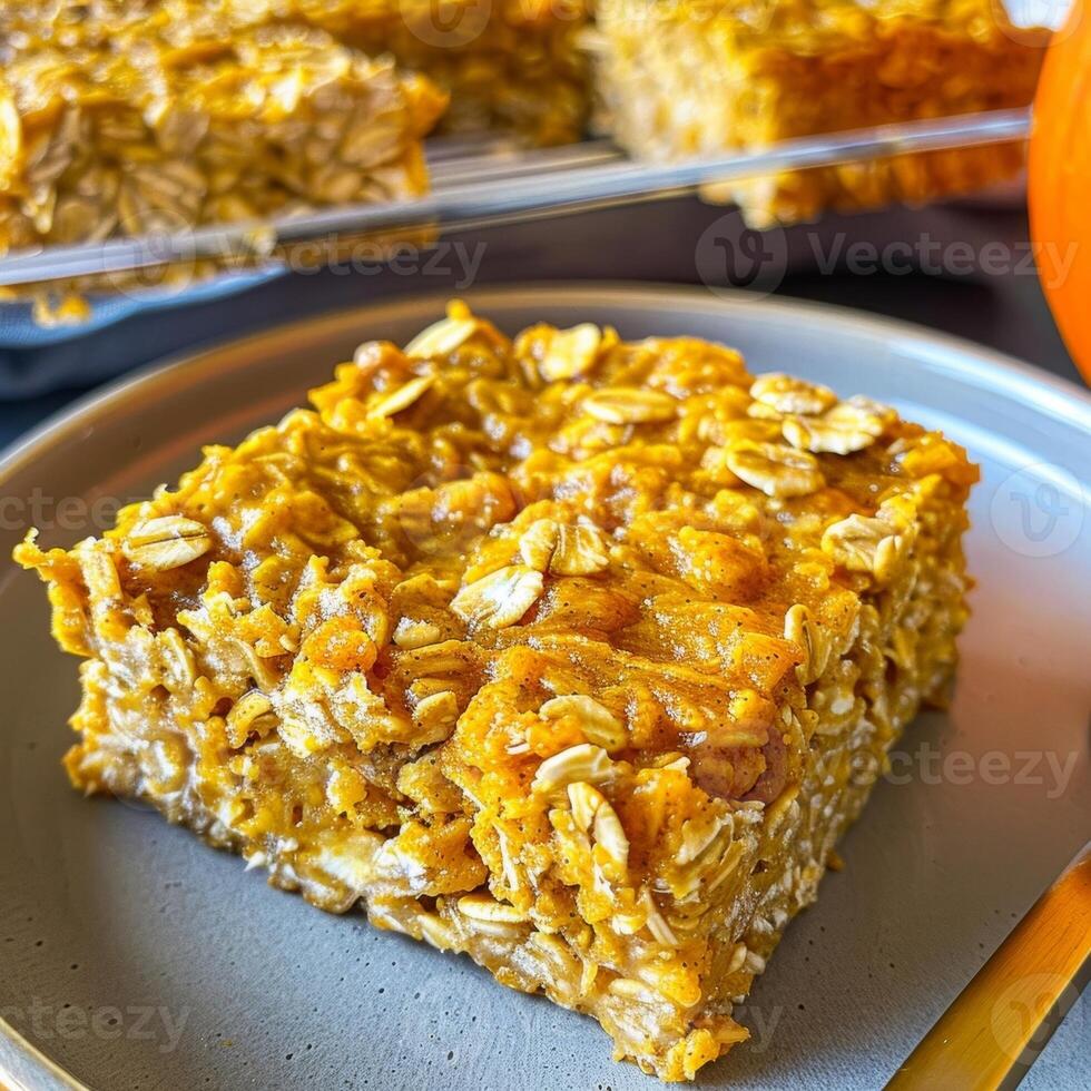 Baked oatmeal squares made with rolled oats pumpkin puree and almond milk perfect for a grabandgo breakfast option photo