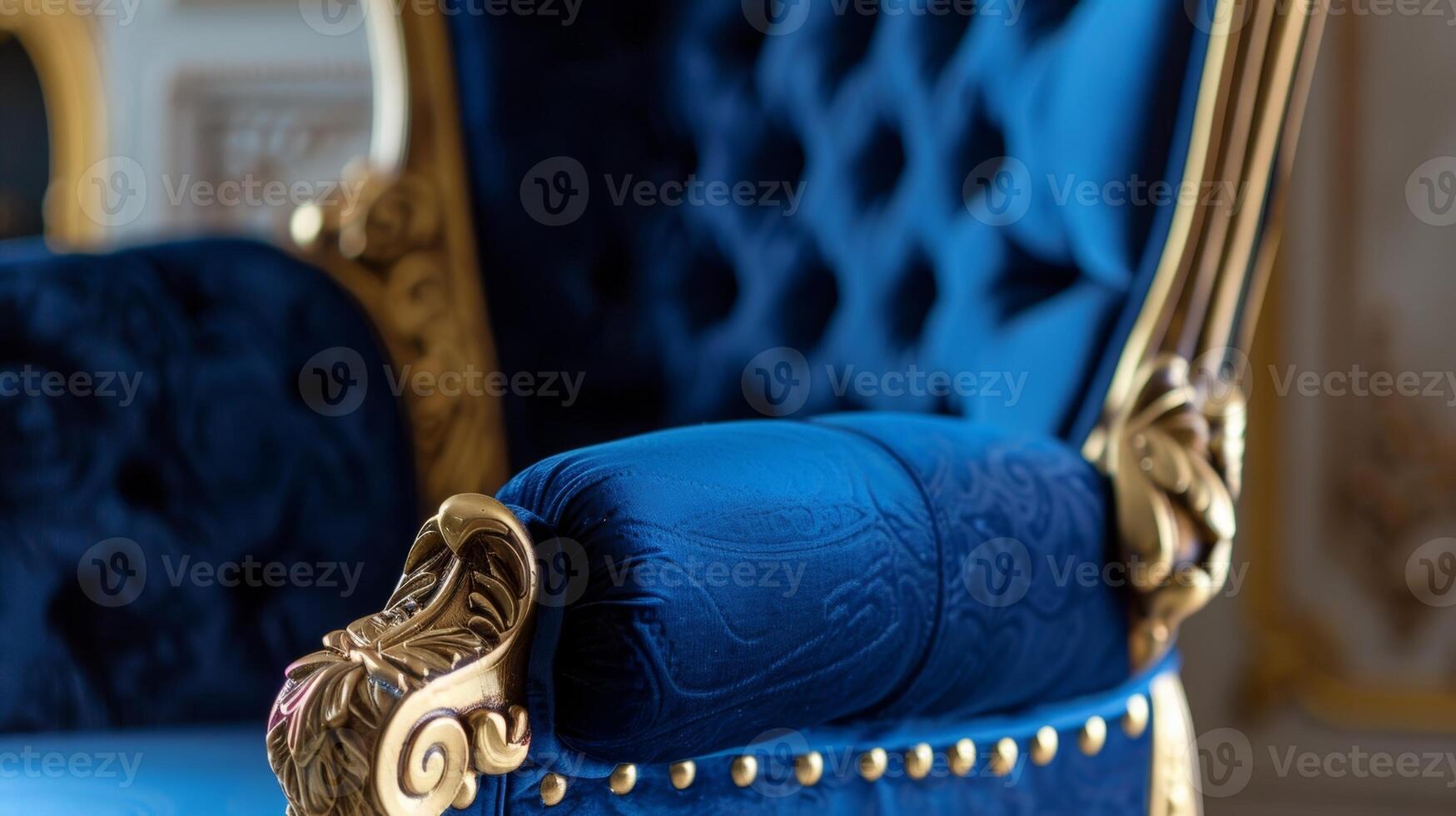 A regal highback chair in royal blue adorned with intricate gold trim and velvet upholstery photo