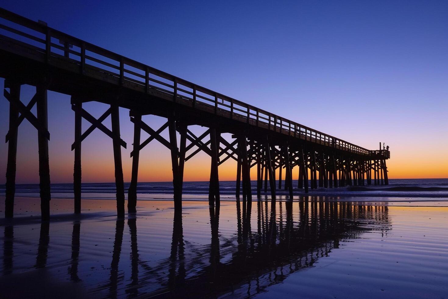 Pier at Sunset with Large Wooden Bridge, Background of Water Reflection photo
