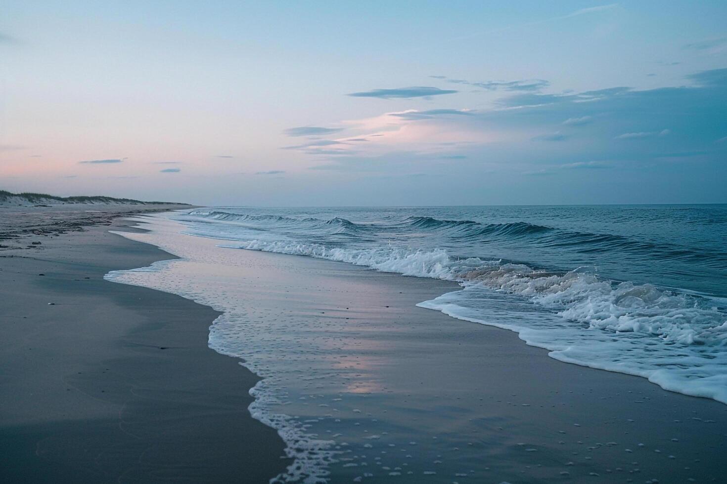 A Beach with Waves and Sand at Sunset photo