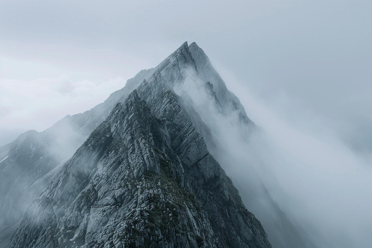 A Mountain Peak Covered in Fog Background photo
