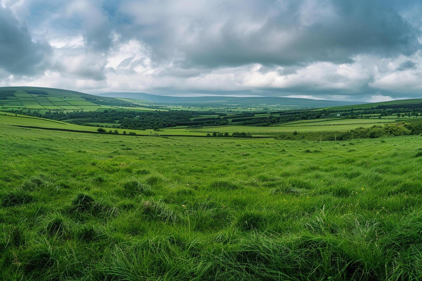 Grassy Field with Cloudy Sky and Hills Background photo