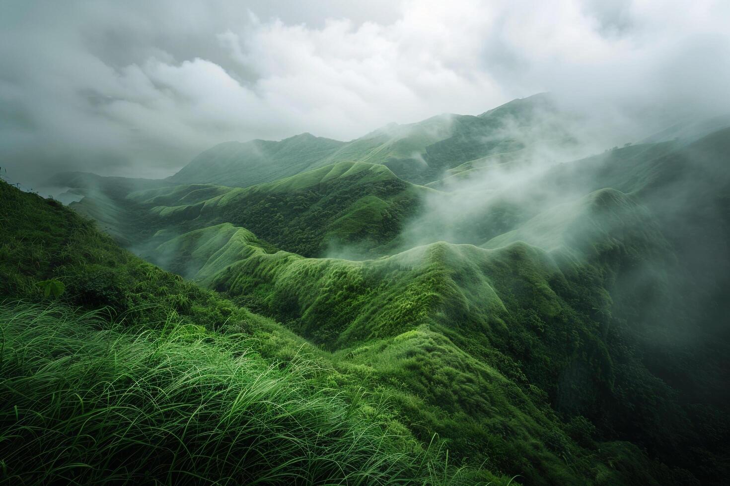 a green mountain range with clouds and grass background photo