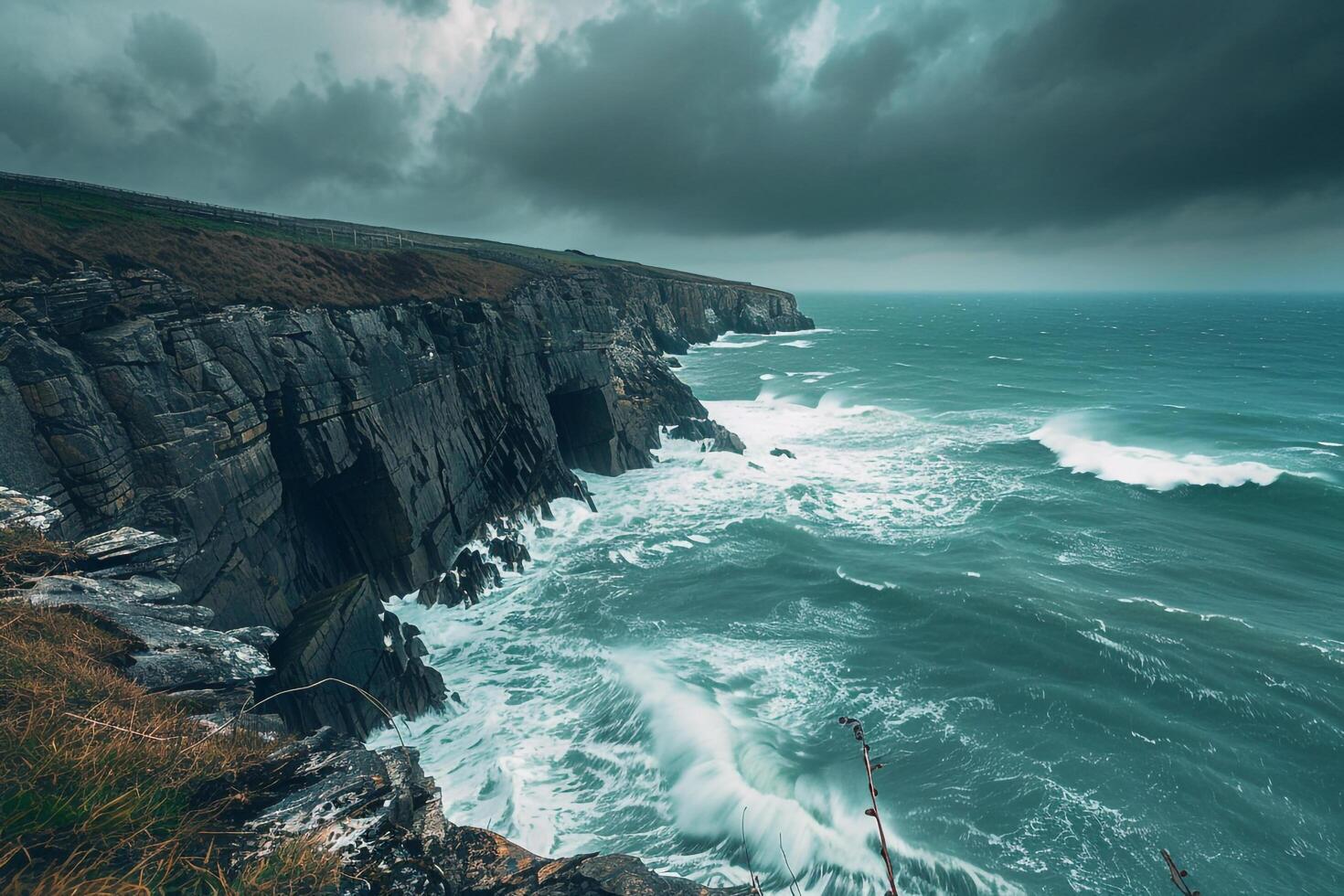 a large cliff with a large ocean in the background photo