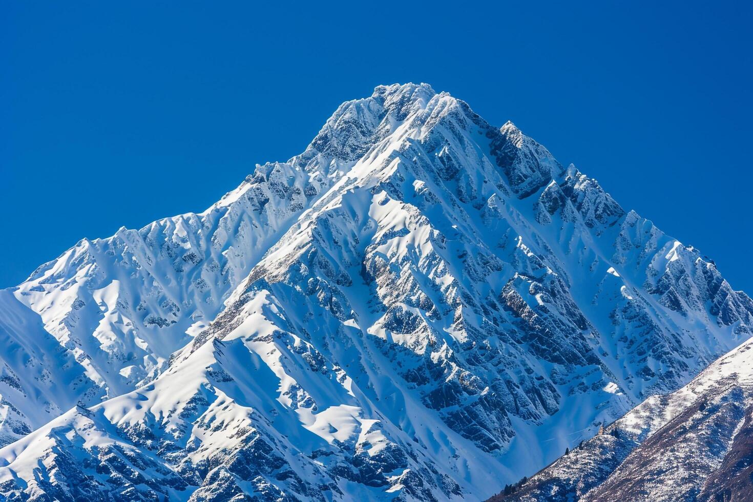 a mountain peak with snow on it and a nature background photo