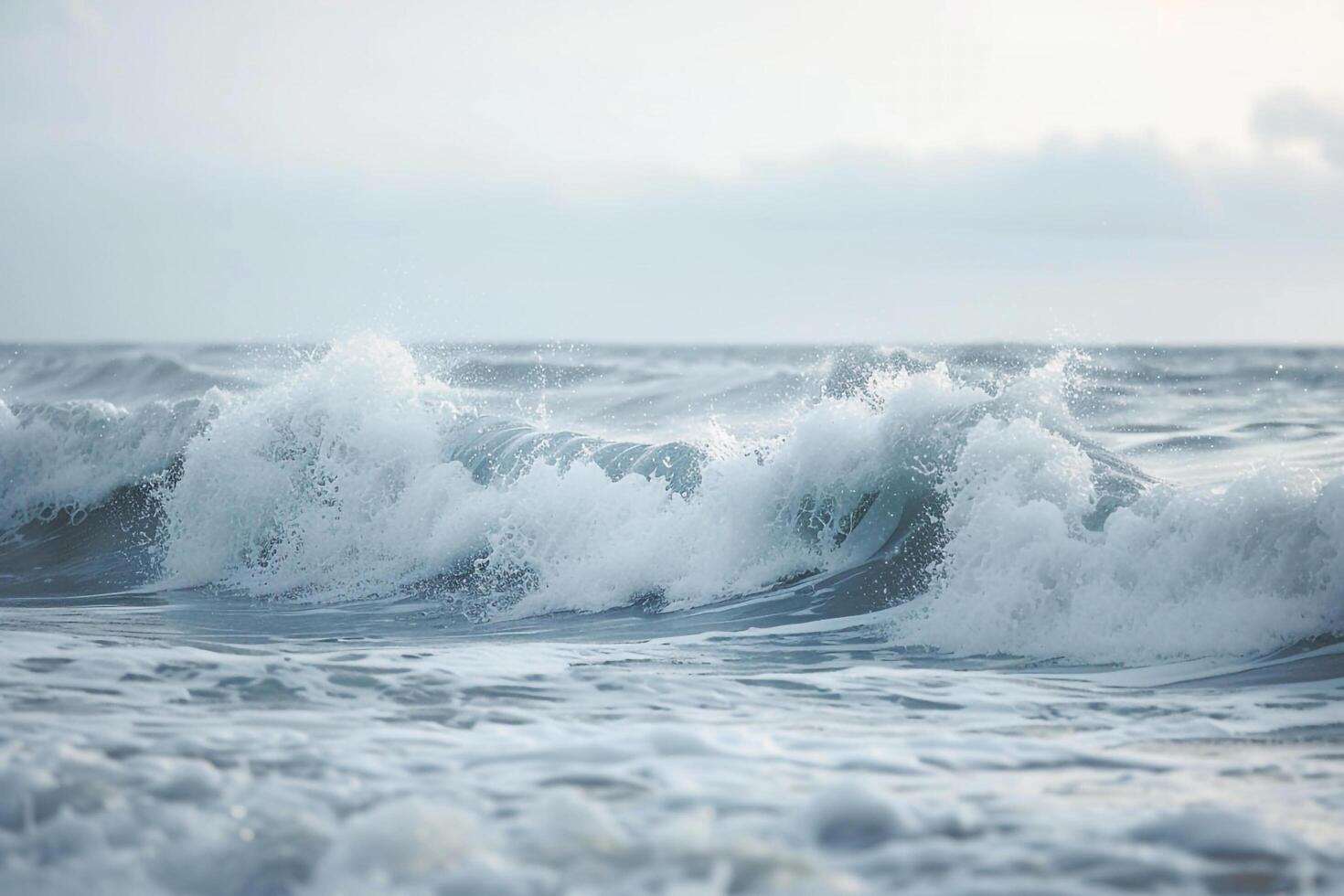 A person is standing on the beach in the ocean background photo
