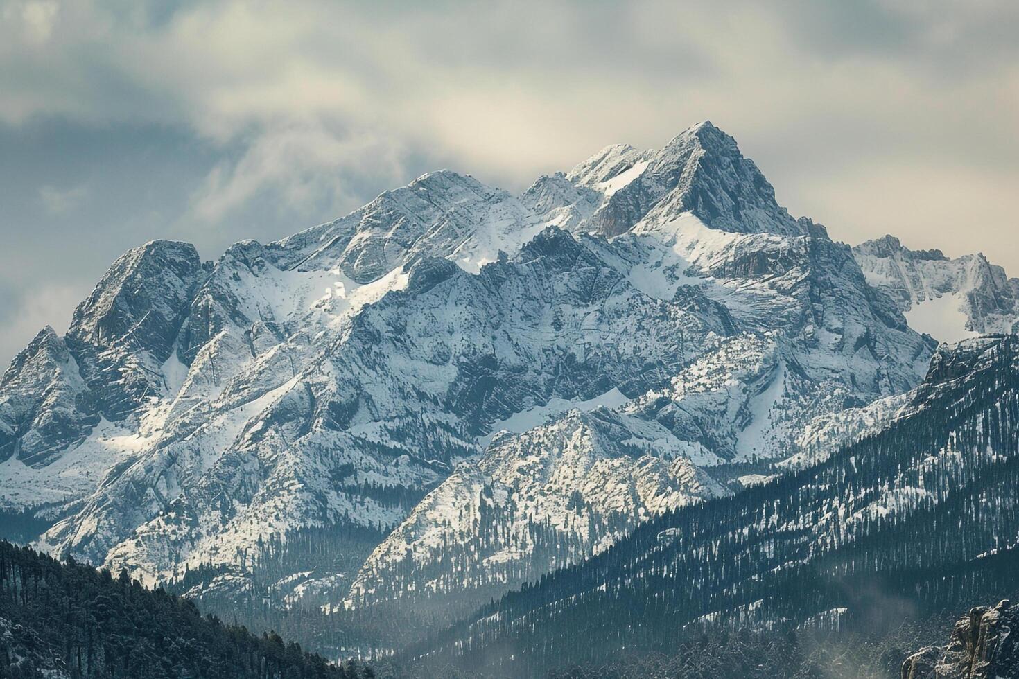 a snowy mountain range with a lake in the foreground background photo