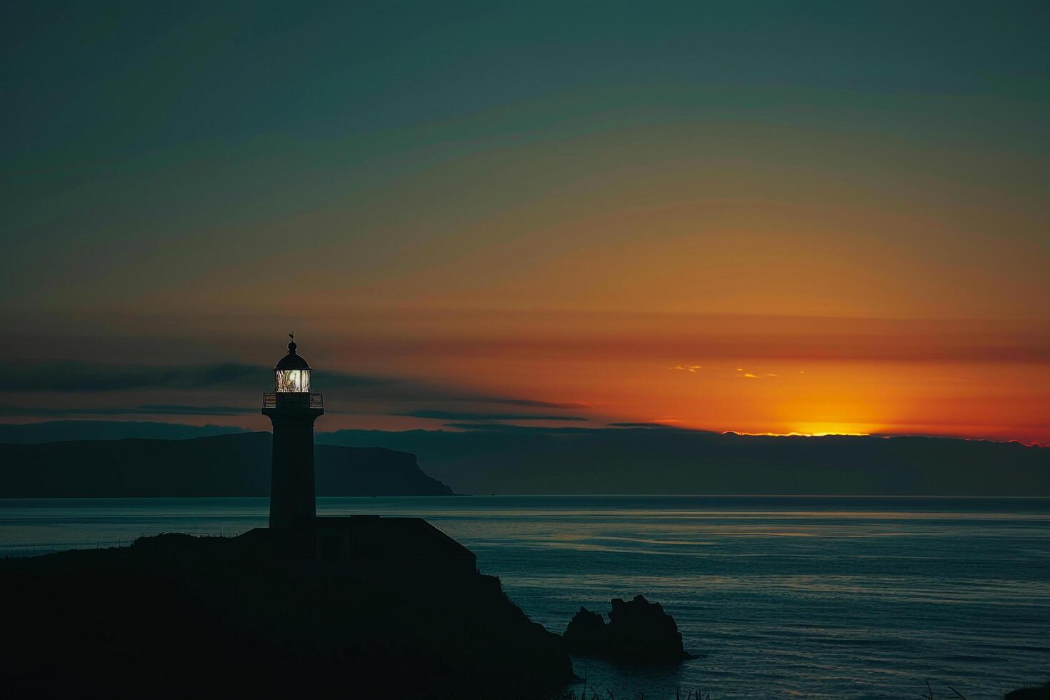 a lighthouse is silhouetted against the sunset background photo