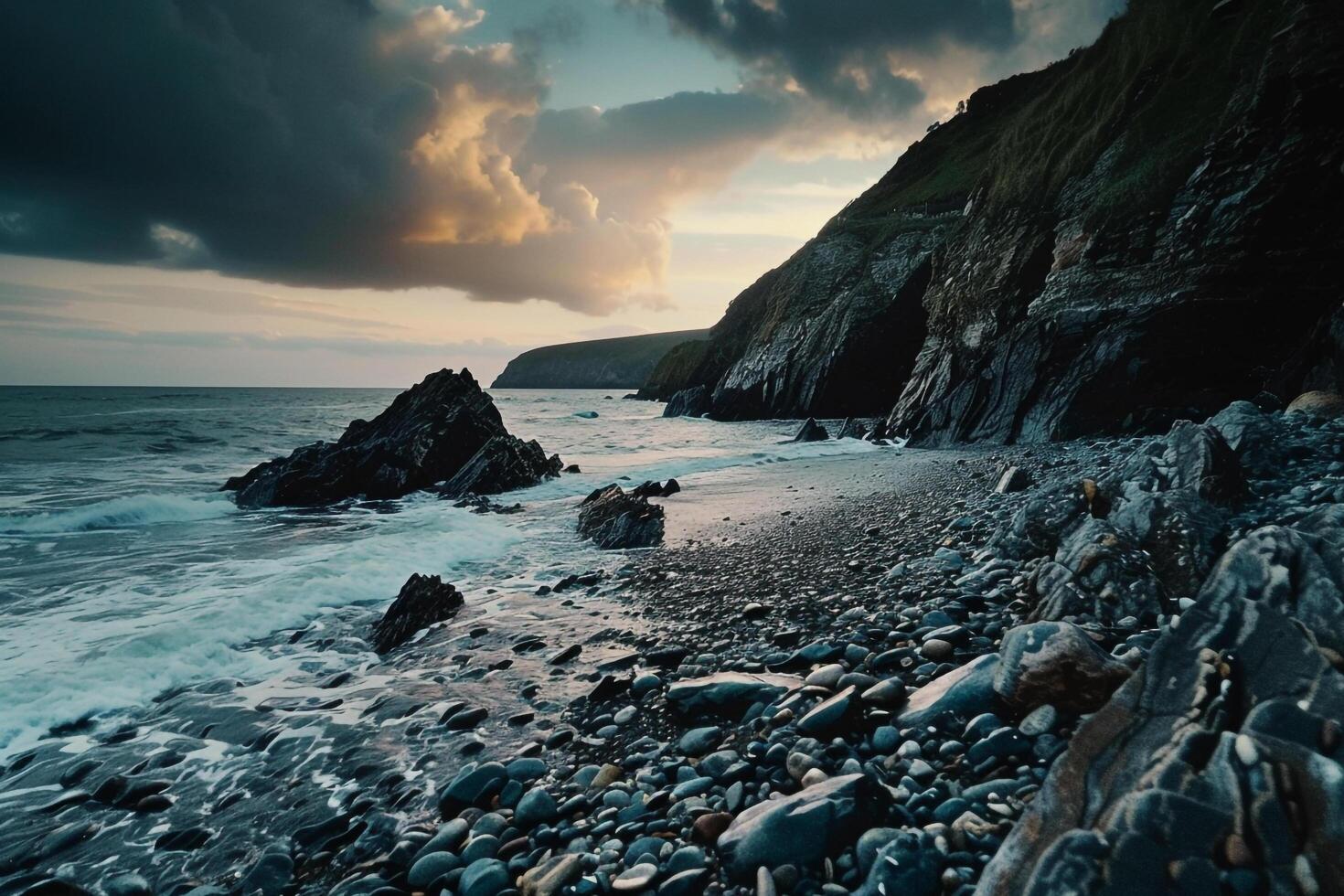 A Rocky Beach with Water and Rocks at Sunset Background photo