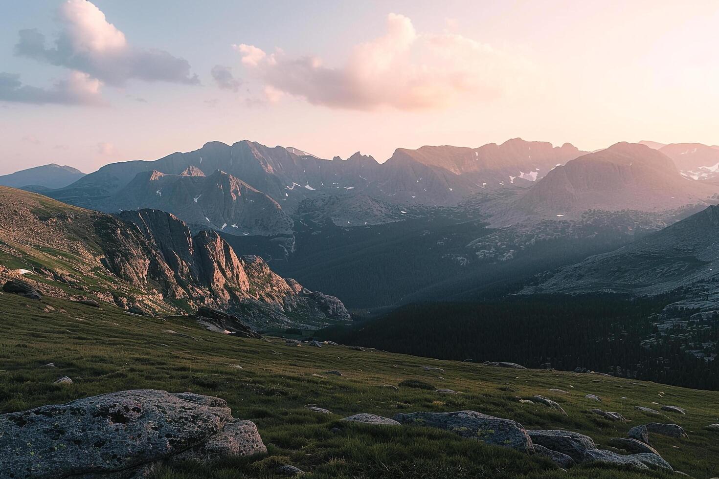 a view of mountains and grassy hills at sunset background photo