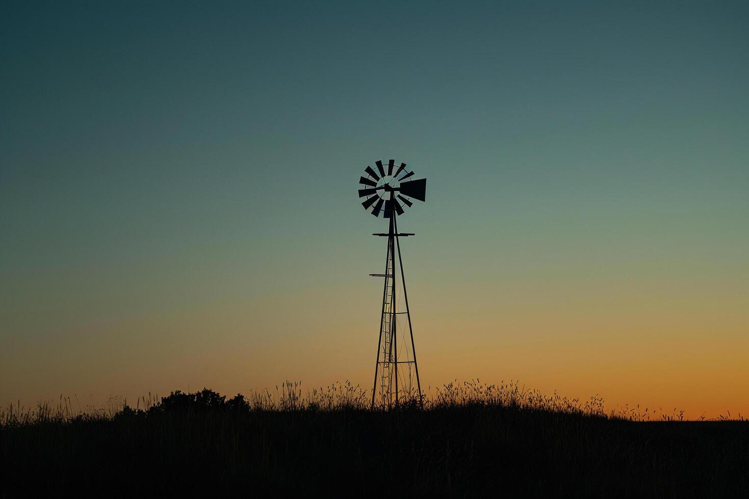a windmill stands in the middle of a field at sunset background photo