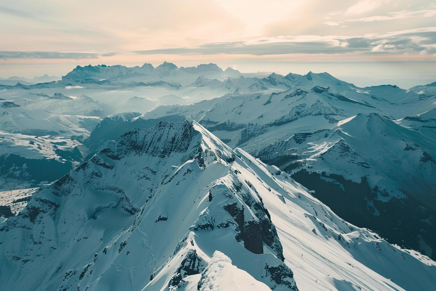 a view of a mountain range with snow covered peaks background photo