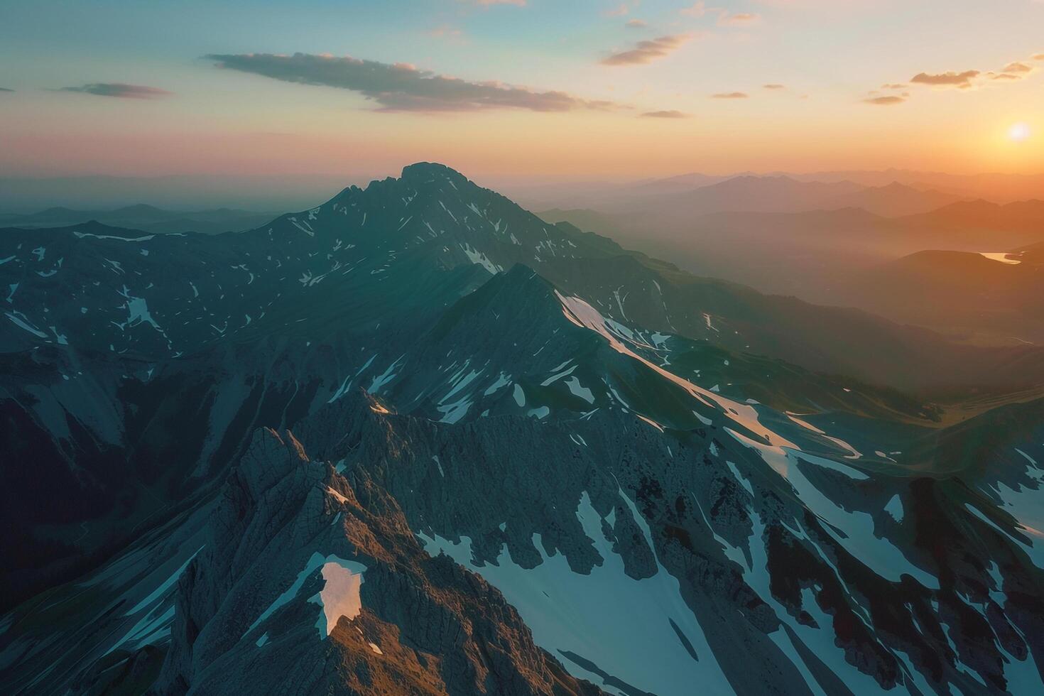 A mountain range with the sun setting over it background photo