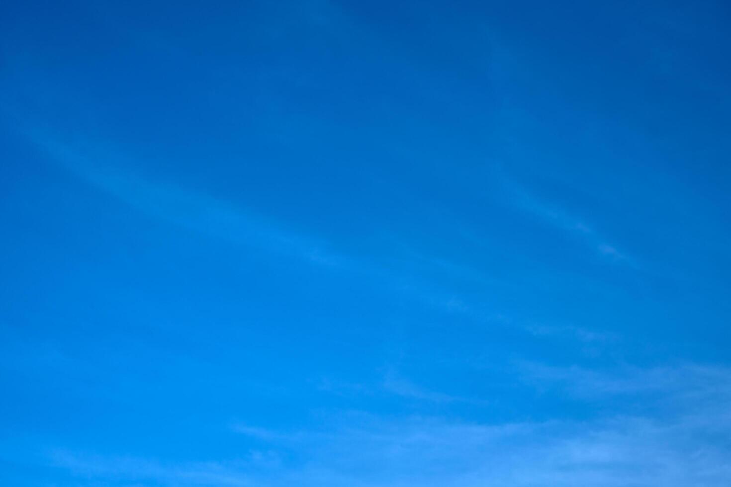 Blue summer sky with small puffy clouds photo