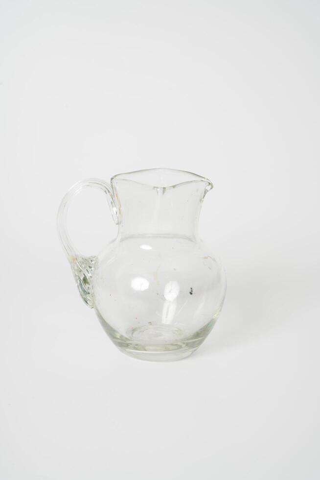 Glass carafe on white background photo